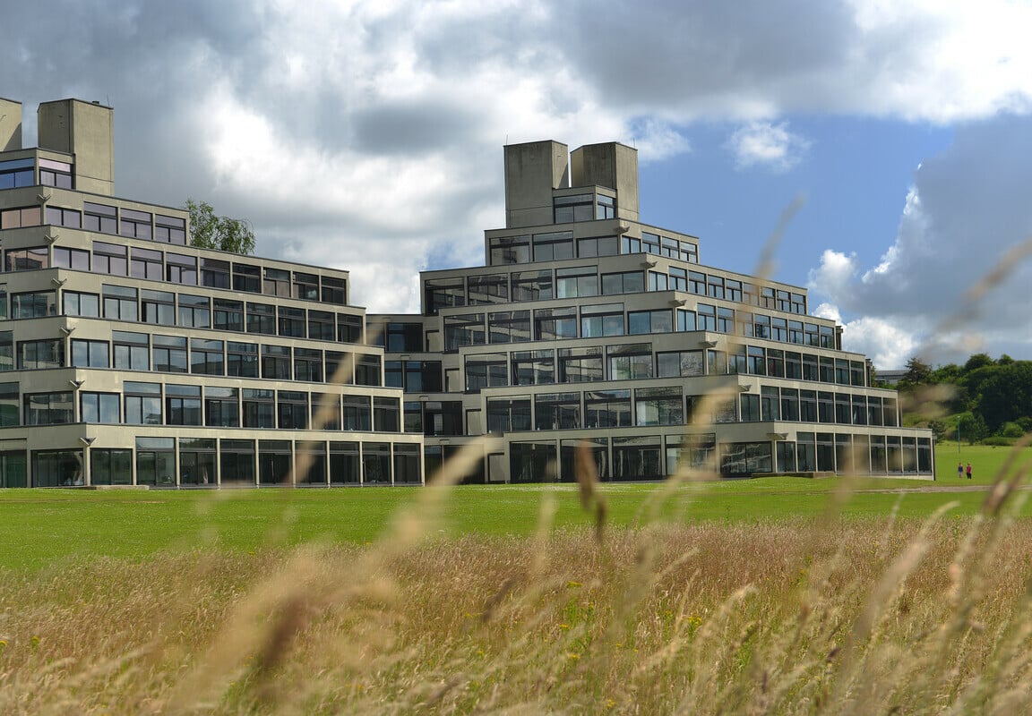 Ziggurat accommodation at the University of East Anglia viewed across a green field