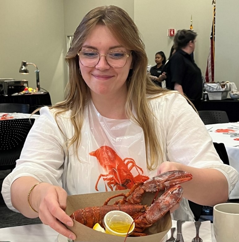 Caroline Jarvis eating lobster at the traditional Gordon Research Conference dinner