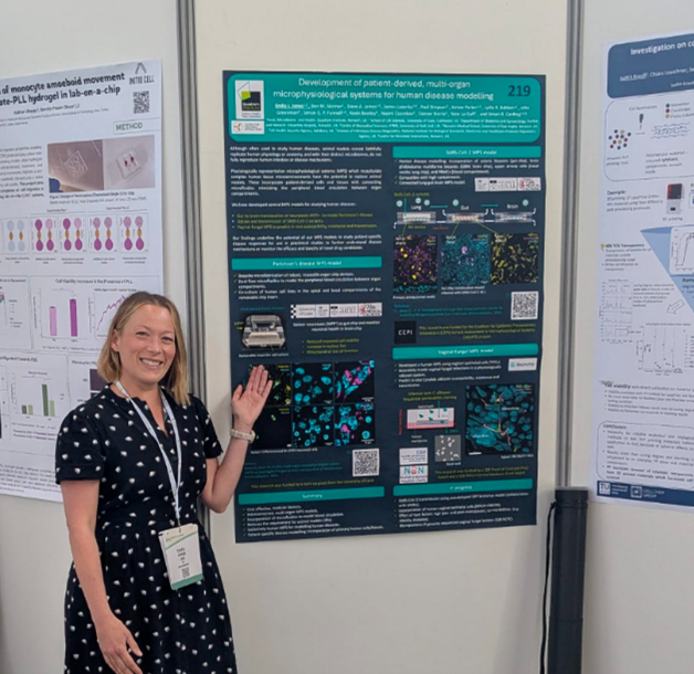 Emily Jones standing in front of her research poster