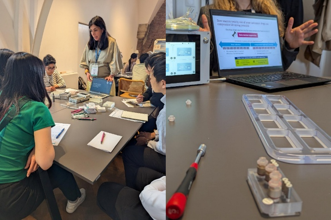 Workshop attendees discussing organ-on-chip devices around a small table