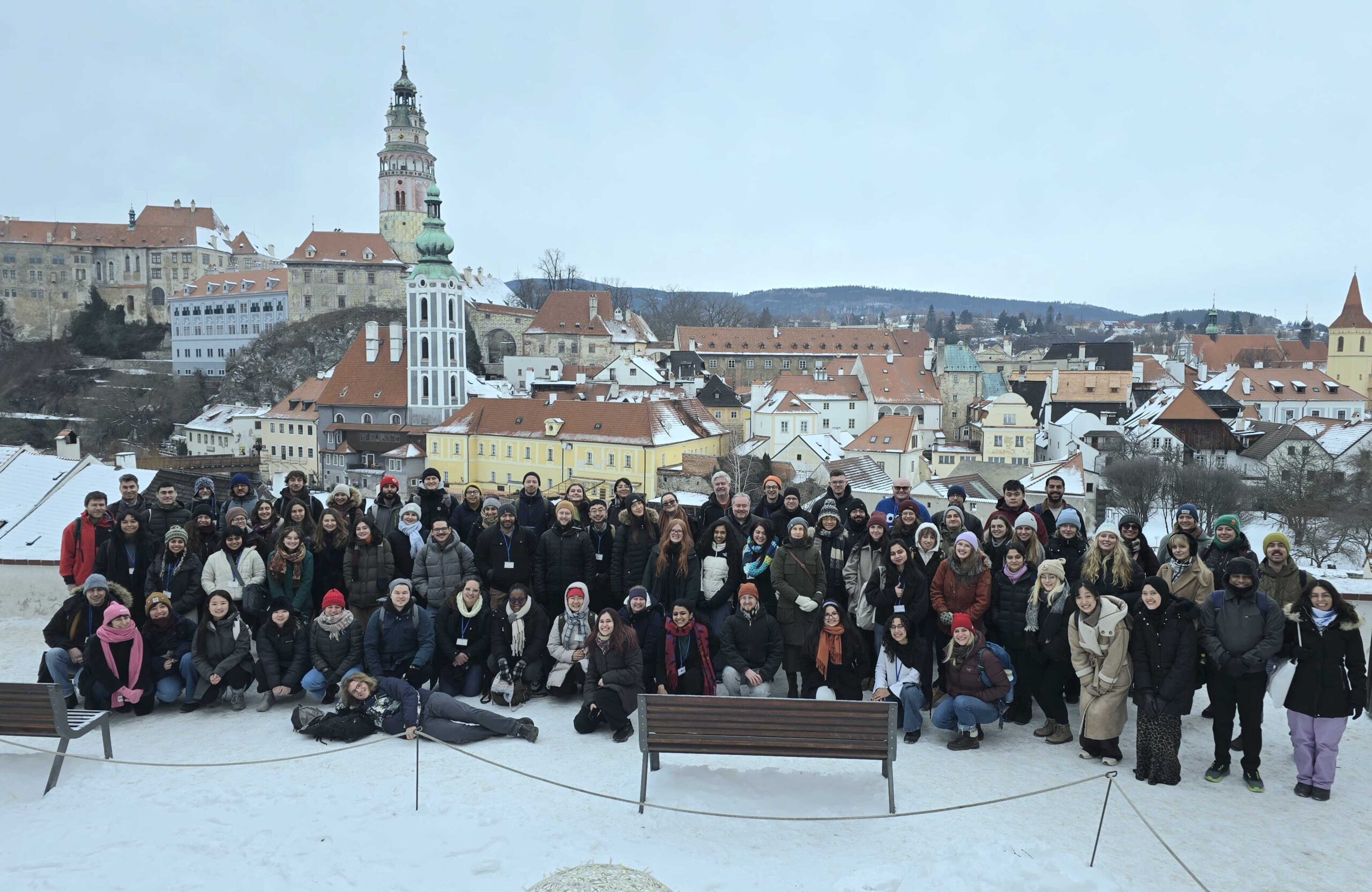 Group photo of training workshop attendees standing outside in front of buildings