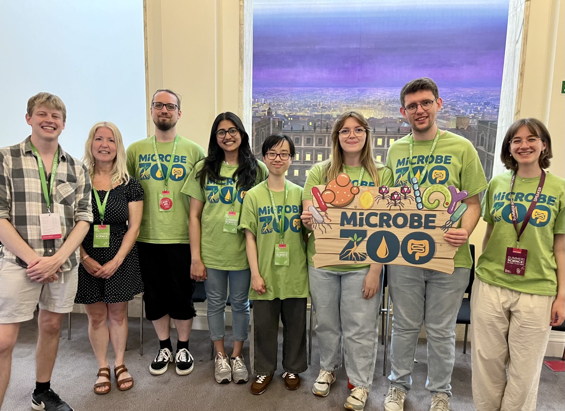 Microbe Zoo volunteers standing in a line wearing green branded t-shirts