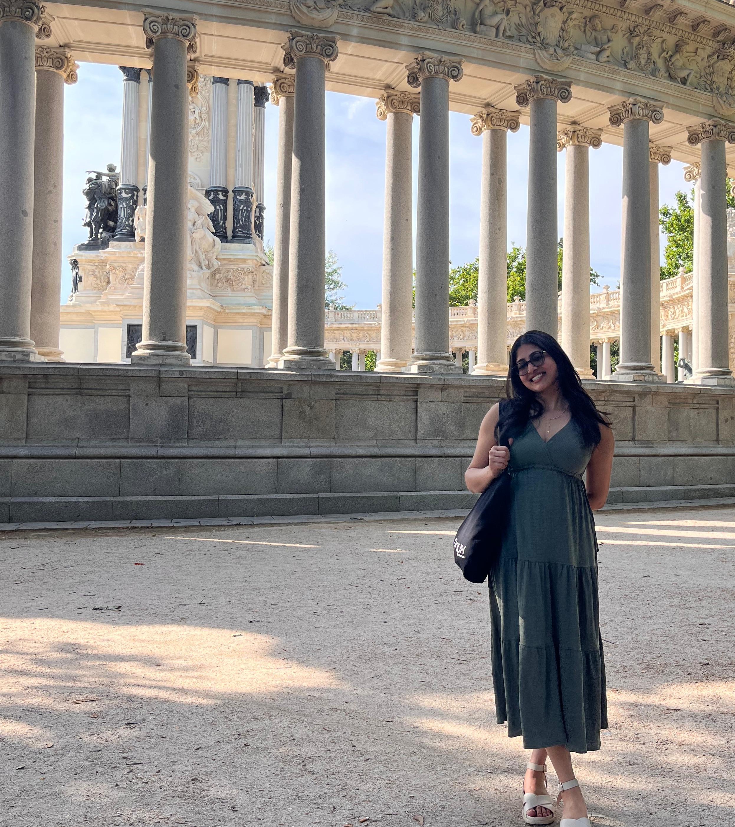 Catherine Philip standing outside in the sun in front of a historic building