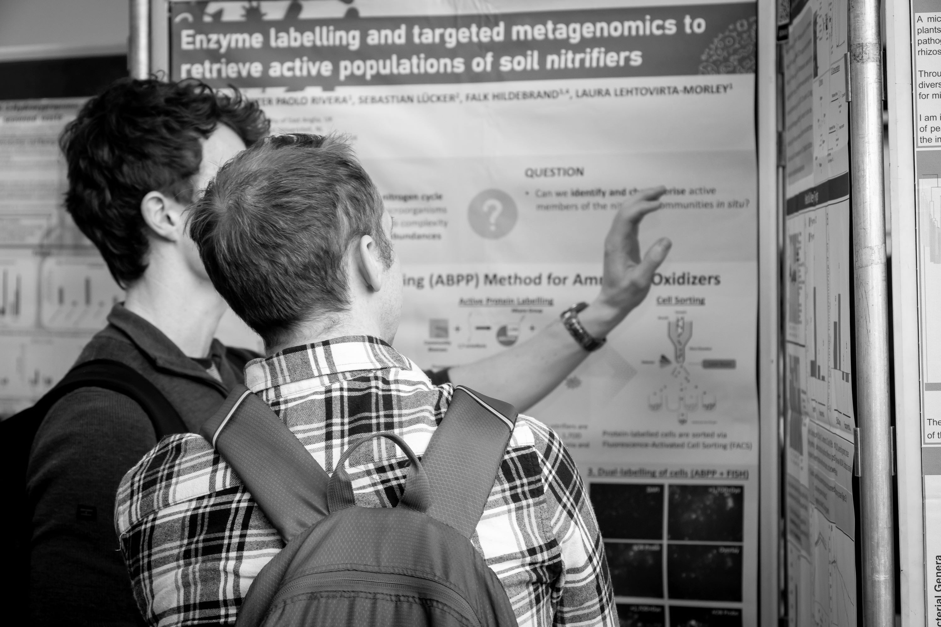Two people discussing at a scientific poster